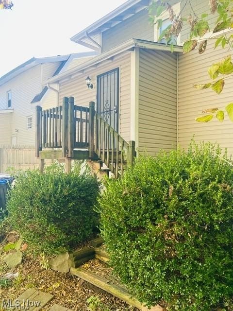 view of side of home featuring fence