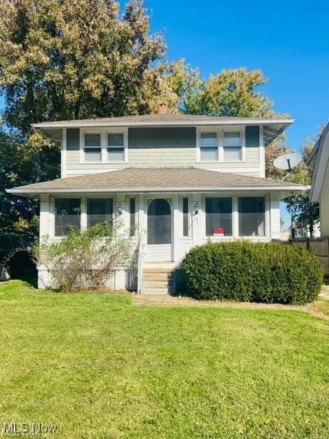 bungalow-style home featuring a chimney and a front lawn