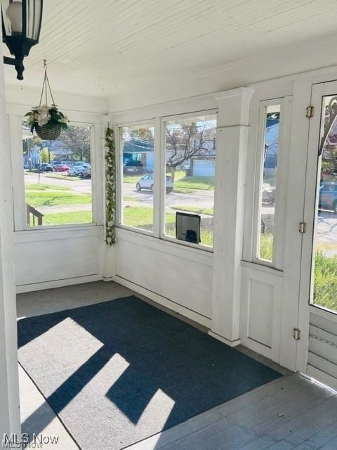 unfurnished sunroom featuring wood ceiling