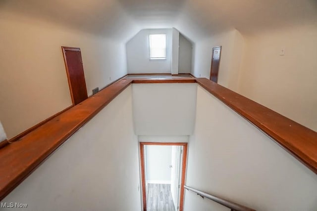 stairway featuring lofted ceiling