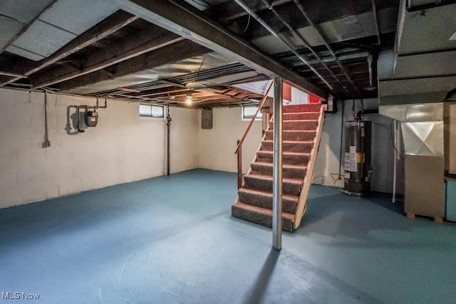 basement with electric panel, heating unit, stairs, and water heater