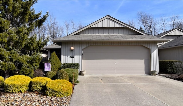 view of front of property with a shingled roof, concrete driveway, and an attached garage