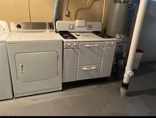 laundry room featuring concrete block wall, laundry area, water heater, and independent washer and dryer