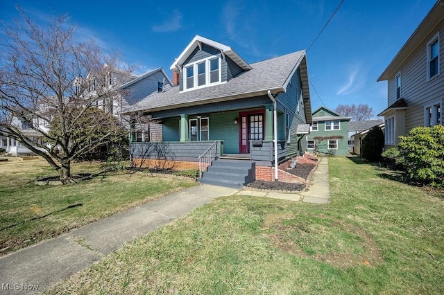 bungalow-style house with a shingled roof, a front lawn, and a porch