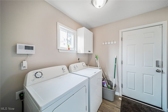 laundry area featuring cabinet space, light wood-style flooring, and independent washer and dryer