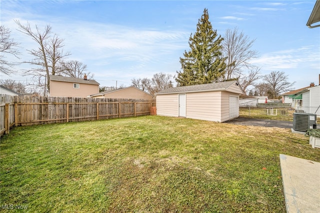 view of yard with an outbuilding, cooling unit, and a fenced backyard