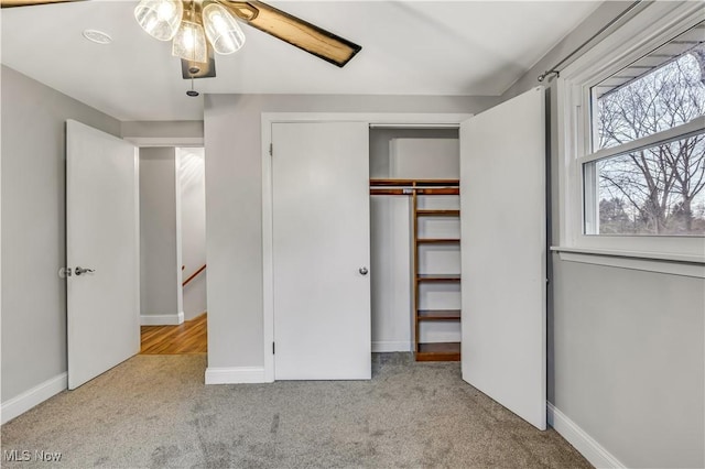 unfurnished bedroom featuring carpet, baseboards, and a closet