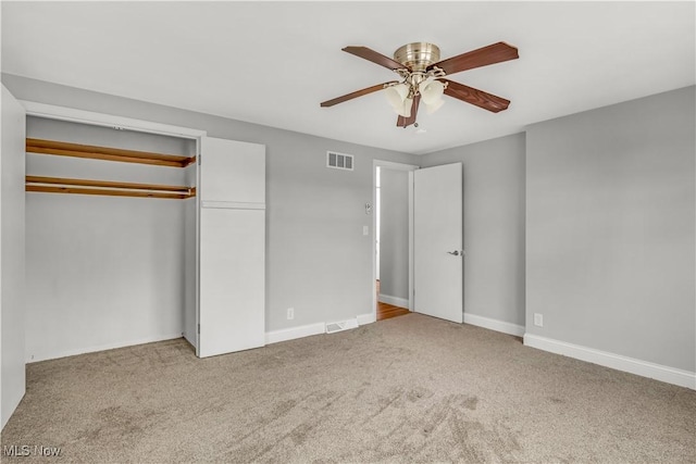 unfurnished bedroom with carpet, a closet, visible vents, and baseboards