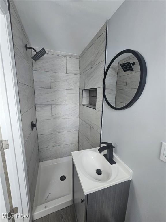 bathroom featuring a shower stall and vanity