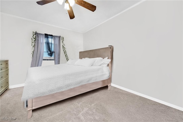 carpeted bedroom featuring crown molding, ceiling fan, and baseboards