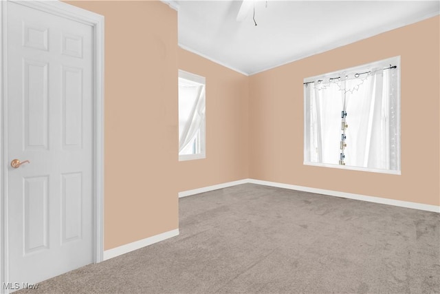 unfurnished bedroom with a ceiling fan, carpet, and baseboards