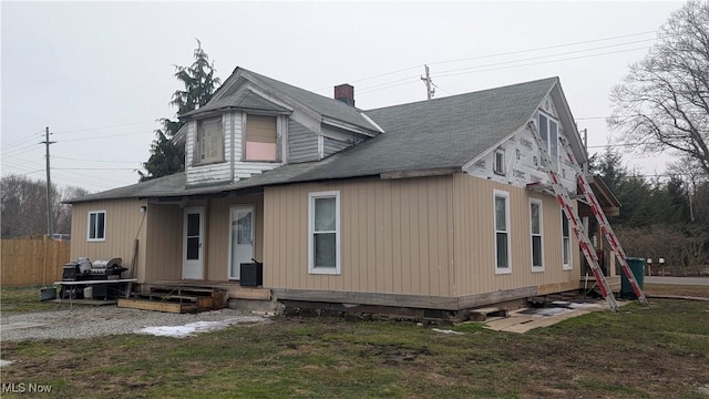 exterior space featuring a yard, fence, and a chimney