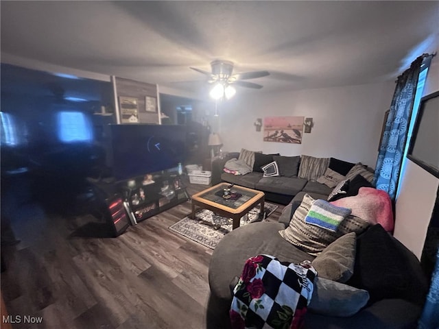 unfurnished living room featuring a ceiling fan and wood finished floors