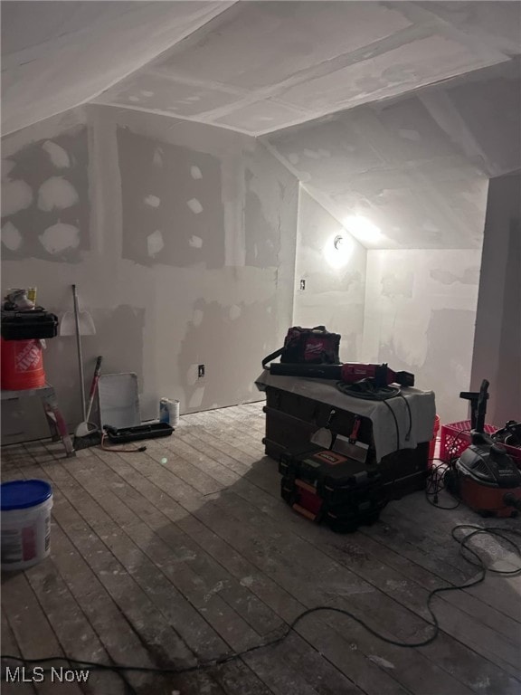 bonus room featuring vaulted ceiling and wood-type flooring