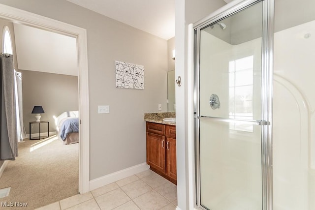 full bathroom with tile patterned floors, a shower stall, baseboards, and vanity