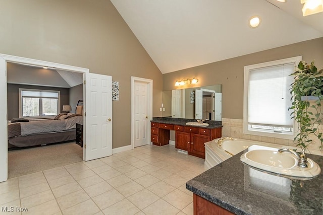 bathroom featuring tile patterned flooring, high vaulted ceiling, a bath, and vanity