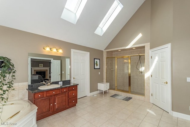 bathroom with a garden tub, lofted ceiling, a stall shower, vanity, and tile patterned floors