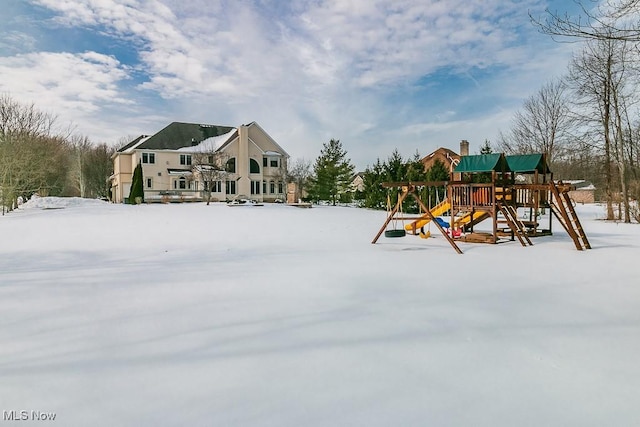 snow covered playground featuring a playground