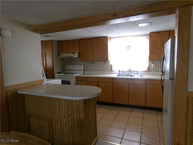 kitchen with light countertops, electric range, ventilation hood, and a sink