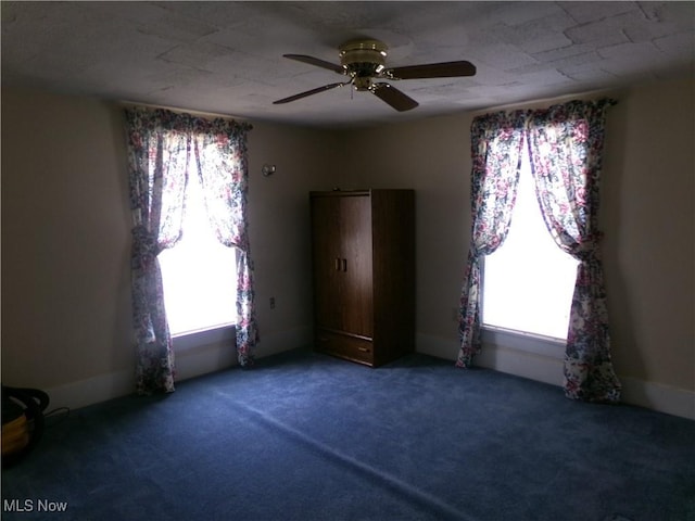 unfurnished bedroom featuring ceiling fan and carpet