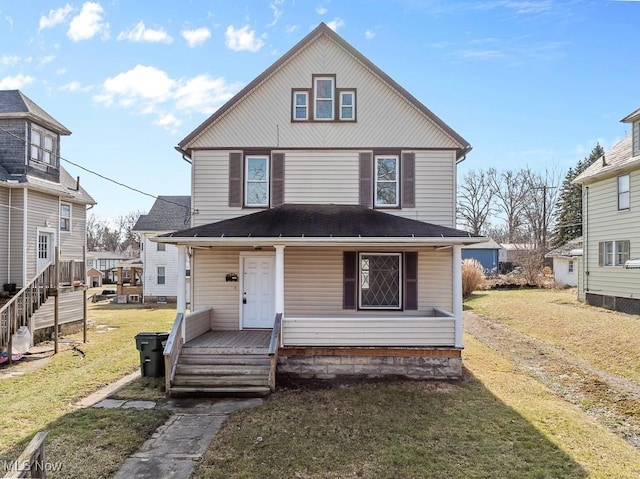 american foursquare style home with a porch and a front lawn