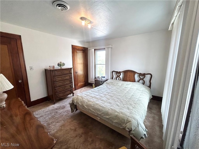 bedroom with carpet floors, baseboards, visible vents, and a closet