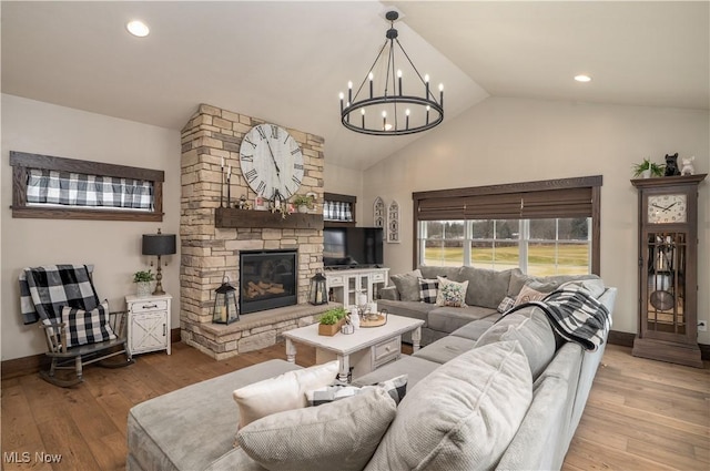 living room with recessed lighting, a fireplace, wood finished floors, baseboards, and vaulted ceiling