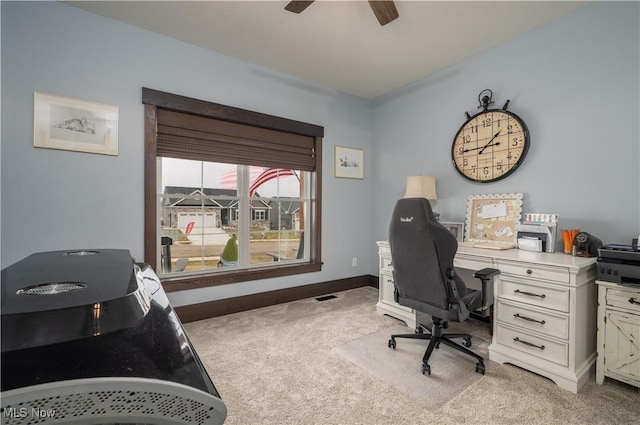 home office with baseboards, ceiling fan, and light colored carpet