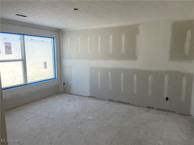 empty room with a textured ceiling