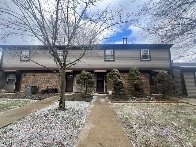 view of front of house featuring brick siding and central AC