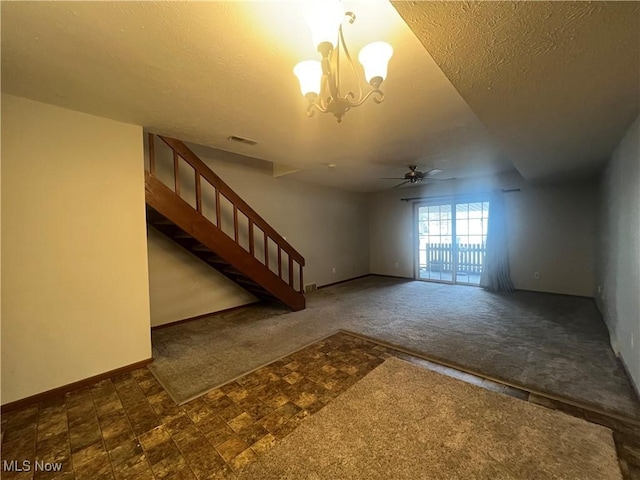 924 Nob Hill Dr Unit 3, Niles, OH 44446 - unfurnished living room with visible vents, ceiling fan with notable chandelier, a textured ceiling, stairway, and carpet