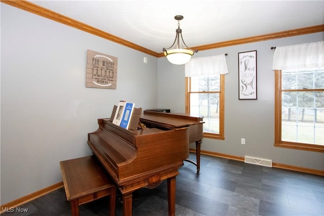 sitting room featuring visible vents, crown molding, and baseboards