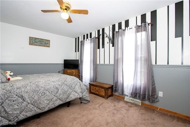 bedroom with a ceiling fan, carpet, and visible vents