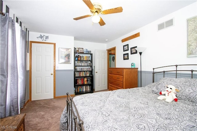 carpeted bedroom featuring ceiling fan and visible vents