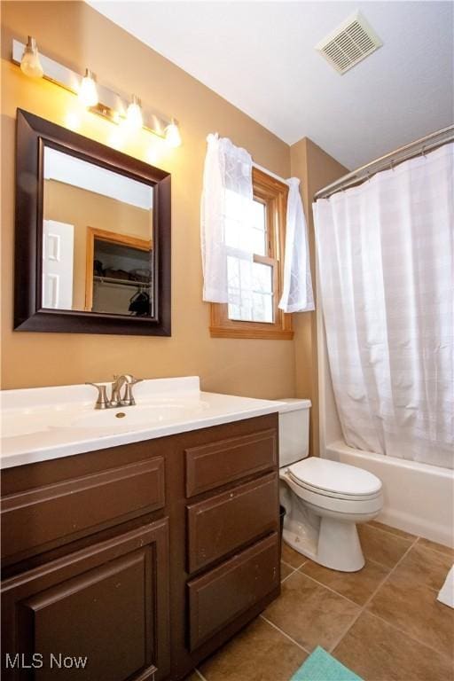 full bath with visible vents, toilet, shower / bath combo, vanity, and tile patterned floors