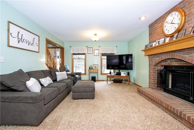 carpeted living area with stairs, a fireplace, and baseboards