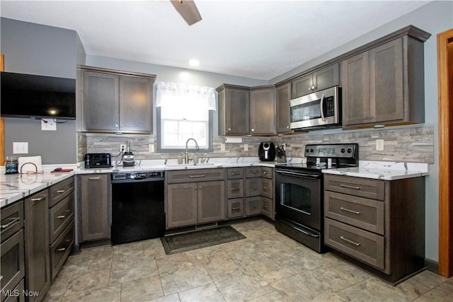 kitchen with black dishwasher, tasteful backsplash, stainless steel microwave, a sink, and range with electric cooktop