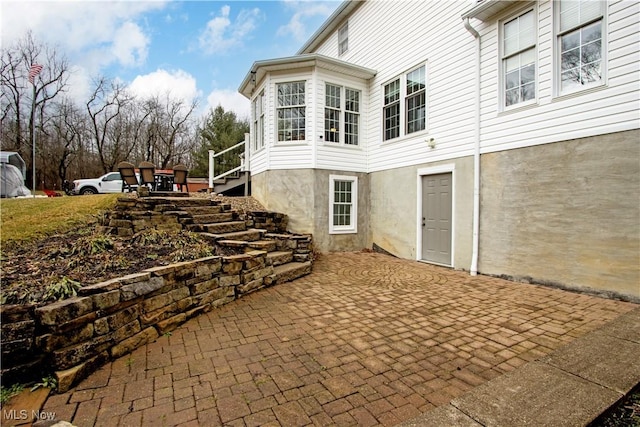 exterior space with stairway and a patio area