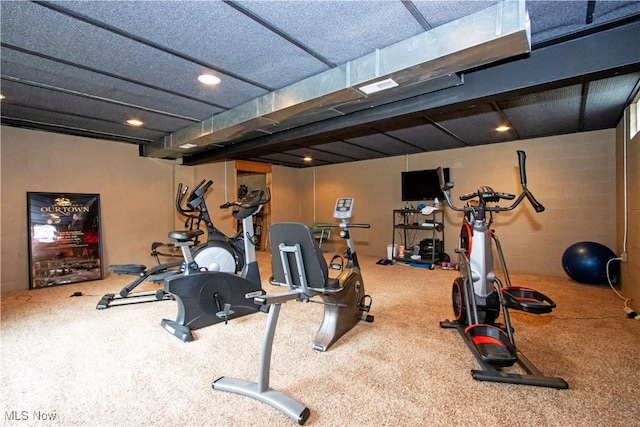 workout area featuring concrete block wall