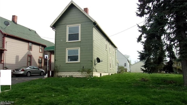 rear view of property with a yard