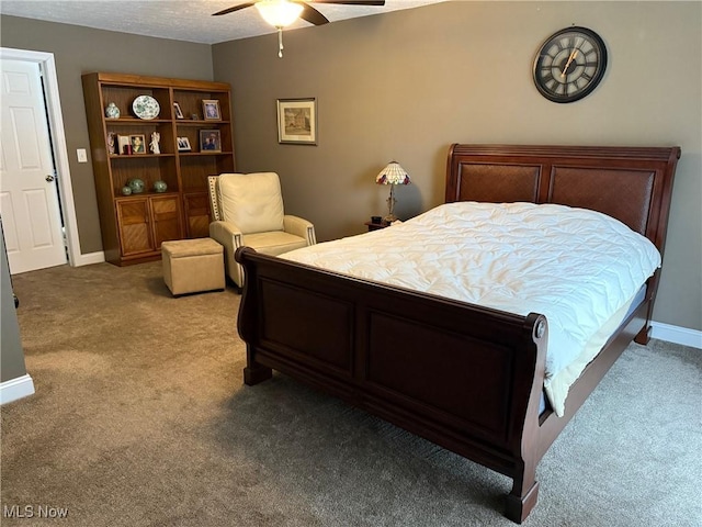 bedroom with carpet floors, a textured ceiling, baseboards, and a ceiling fan