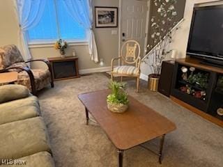 living area featuring baseboards