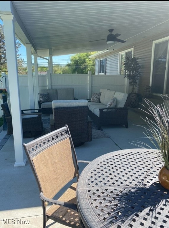 view of patio / terrace featuring ceiling fan, fence, and an outdoor living space