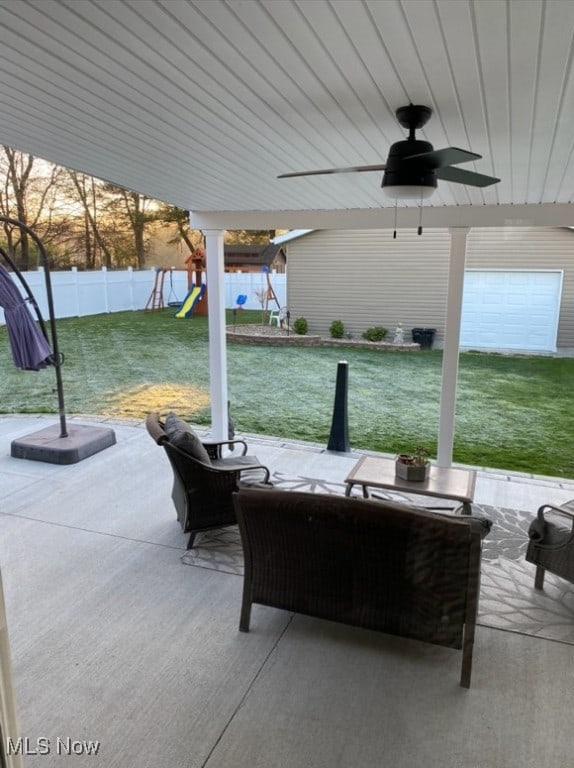 view of patio / terrace with a fenced backyard, a ceiling fan, and a playground