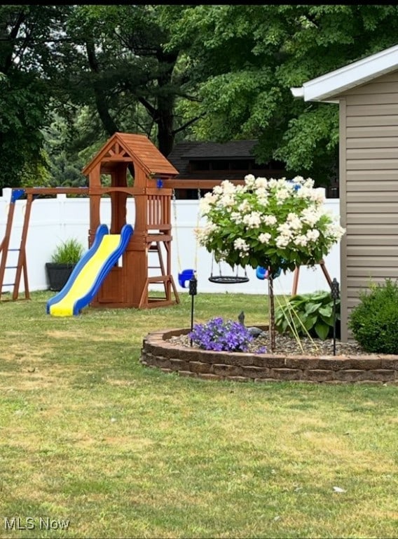 view of playground featuring a lawn