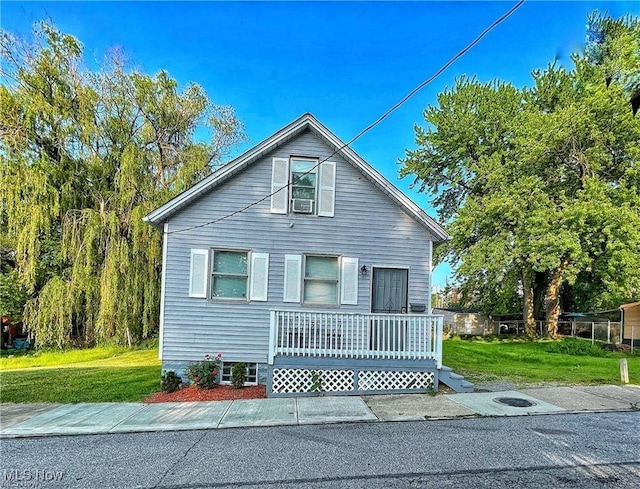 bungalow-style home with a front yard