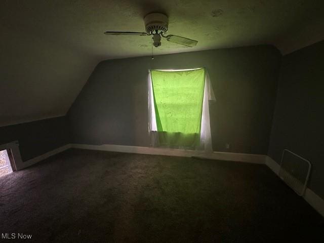 additional living space with a healthy amount of sunlight, baseboards, carpet floors, and vaulted ceiling