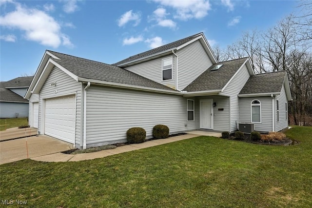 traditional-style house with a garage, a shingled roof, a front lawn, and concrete driveway