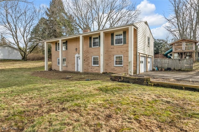 exterior space featuring a garage, aphalt driveway, and fence