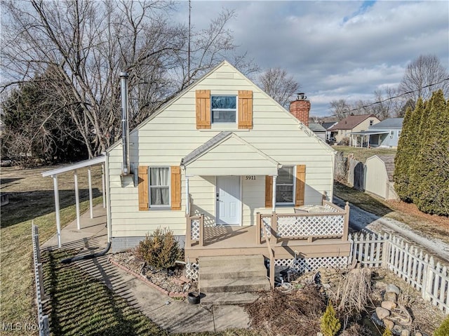 rear view of house featuring fence